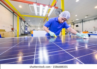 Technician Worker Cleaning New Solar Panel On Production Line On Factory Floor