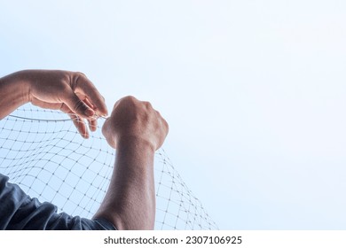 technician worker man install plastic net for protect pigeon bird in balcony apartment. Professional service man setup netting birds for clean and hygiene. Isolated on blue sky background