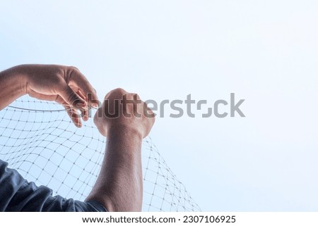 technician worker man install plastic net for protect pigeon bird in balcony apartment. Professional service man setup netting birds for clean and hygiene. Isolated on blue sky background