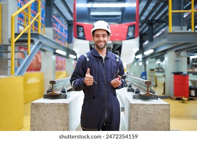 Technician or worker smiling and thumbs up pose at construction train station - Powered by Shutterstock