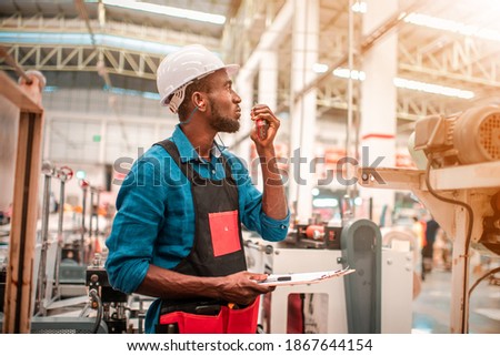 Technician working in factory check functionality while commissioning a production line, Man working