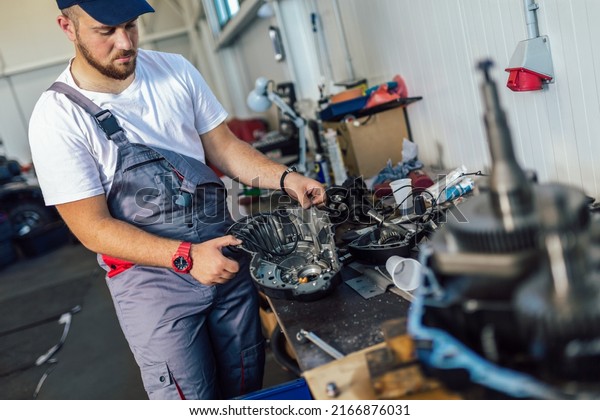 Technician working on checking and service car in\
workshop garage; technician repair and maintenance engine of\
automobile in car\
service