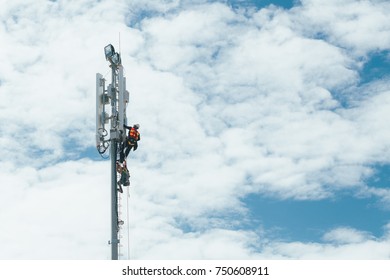 Technician Working On Communication Tower With Engineer For Digital Age Development Concept