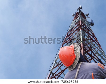 Technician working on Communication tower with sunset blue sky background