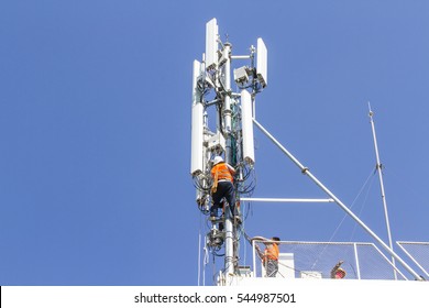 Technician working on communication towers background is blue sky. 