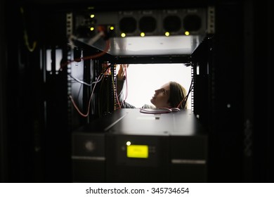 Technician working on the server at the data centre