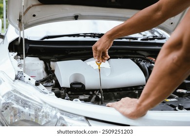 A technician in a workshop uses a wireless device to check a car's condition, updating a digital certificate. The scene highlights automotive repair, service, and efficiency in maintenance.