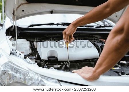 A technician in a workshop uses a wireless device to check a car's condition, updating a digital certificate. The scene highlights automotive repair, service, and efficiency in maintenance.