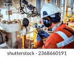 Technician,Instrument technician on the job calibrate or function check on instrument device or level transmitter in oil and gas platform offshore.