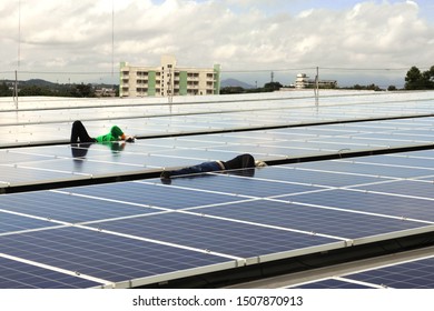 Technicians Arranging Cable Solar Rooftop System