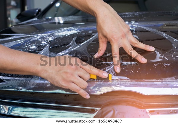 Technicians at the car center are\
installing car films.  style professional management\
business