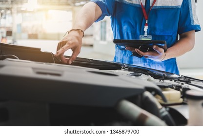 Technicians are checking the condition of the car according to the month. The technician uses the tablet to check.