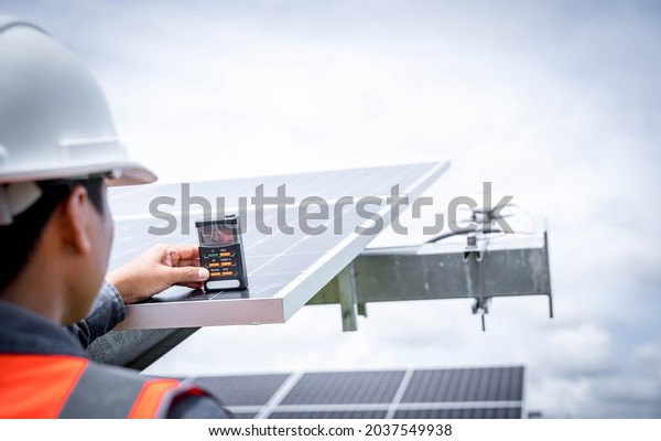Technicians are checking the irradiance of the\
solar panel in the solar power plant so that the power generation\
can operate at full capacity. Alternative energy to conserve the\
world\'s energy.