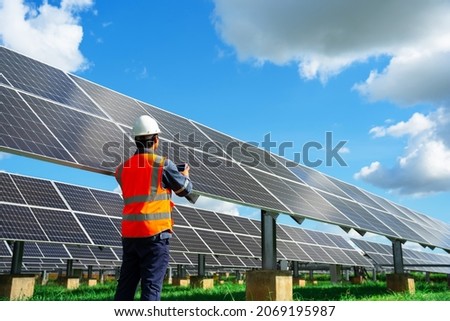 Technicians are checking the operation of the solar power plant equipment so that the power generation can operate at full capacity. Alternative energy to conserve the world's energy.