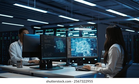 Technicians coworkers using AI tech on computer to do checkup in server room. Teamworking colleagues in data center using artificial intelligence technology to process datasets for training, camera B