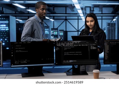 Technicians in data center using devices to check for server performance issues arising due to high CPU usage. Server farm staff members fixing insufficient memory errors slowing down hardware