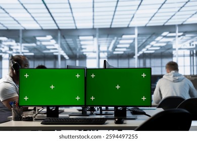 Technicians in data center using green screen PCs to coordinate deployment of server architecture. Server hub workers configuring and testing equipment with chroma key computers