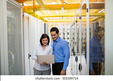 Technicians Discussing Over Laptop In Server Room