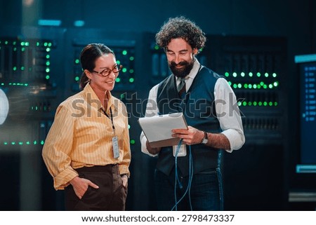 It technicians discussing server room operations, team collaborating on network administration and data management