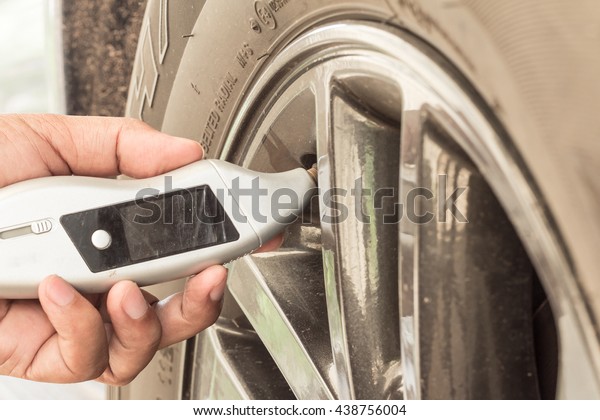  \
technicians hand are measured  tire pressure\
.