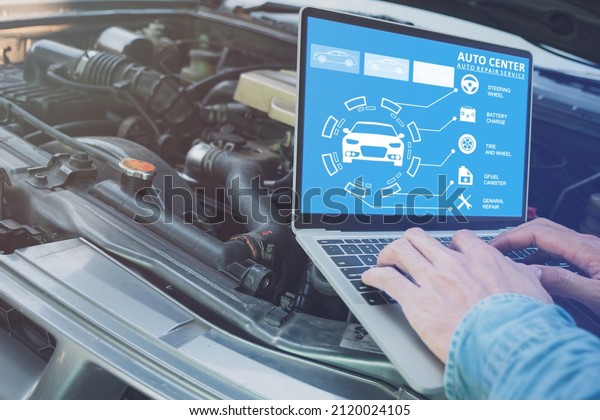 Technician\'s hand using computer analyze the\
data of the car To check engine operation, technology for vehicle\
maintenance\
concept.