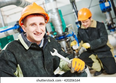 technicians of heating system in boiler room