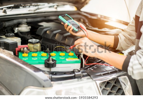 Technicians inspect\
the car\'s electrical\
system.
