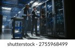 Technicians inspect and maintain server racks in a modern data center, using a tablet to monitor equipment, check connections, operation of network hardware, mainframe, server racks.