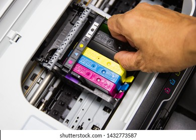 Technicians are install setup the ink cartridge or inkjet cartridge is a component of an inkjet printer 