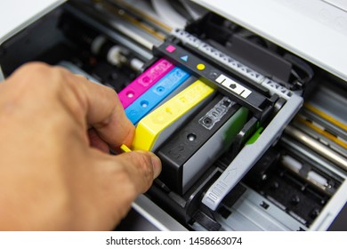Technicians are install setup the ink cartridge or inkjet cartridge is a component of an inkjet printer  - Shutterstock ID 1458663074