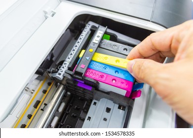 Technicians are install setup the ink cartridge of a inkjet printer the device of office automate for printing - Shutterstock ID 1534578335