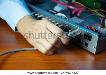 Technicians installing LAN cables at CCTV camera recorders