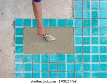 Technicians are installing swimming pool tiles.