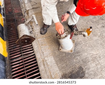 Technicians performing preventive maintenance and reassembly of an industrial oil filter with gasket sealant application at an oil and gas processing facility. The image highlights field service, equipment reliability, and mechanical maintenance.