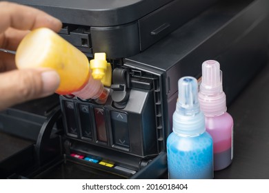  Technicians Refill ink cartridges, printer Inkjet colors.Printer Repairs and Maintenance inkjet or Laser printers concept ,selective focus    - Shutterstock ID 2016018404