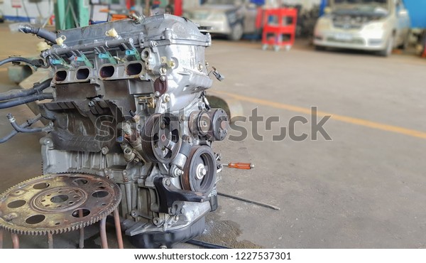 Technicians are repairing the engines of cars and\
spare parts.