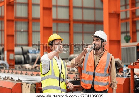 Technicians and supervisors are drinking water to cool off from the heat of working in the factory during the summer.