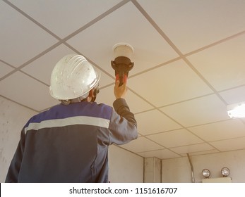 Technicians Are Testing Smoke Alarm On White Ceiling.