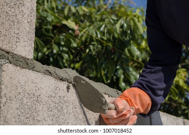 Technicians are working to build a brick wall