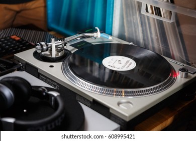 Technics SL 1200 turntable with a vinyl record. Listen to the music in high fidelity. EUROPE-6 MARCH,2017 - Shutterstock ID 608995421