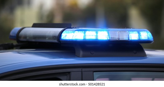 Technological Blue Flashing Of The Police Car During A Chase Between Cars