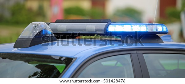 technological blue flashing of the police car\
during the checkpoint to check\
motorists