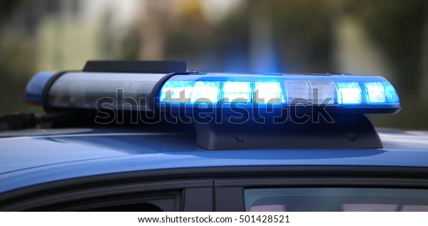technological blue flashing of the police car during\
a chase between\
cars
