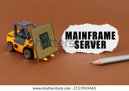 Technological concept. On a brown surface, a forklift is transporting a processor, next to it is paper with the inscription - Mainframe Server
