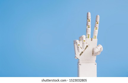 Technological peace. Android Robot hand showing v-sign on blue background, empty space - Powered by Shutterstock