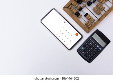 Technological progress concept. Calculation, counting technologies development. Old wooden abacuses, calculator and smartphone with calculator on white background. Top view. Blank space - Shutterstock ID 1864464802