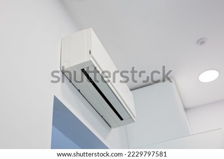 Technologies for cleansing the air in the room, a powerful air conditioner over the doorway in the clinic. Ventilation of premises, installation of air conditioners