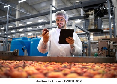 Technologist doing quality control of apple fruit production in food processing plant. - Powered by Shutterstock