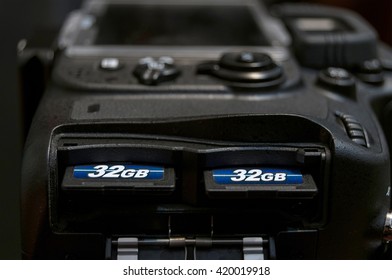 Technology background. Two SD memory flash card in DSLR camera.