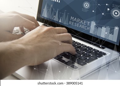 technology and business concept: man using a laptop with market research software on the screen. All screen graphics are made up. - Shutterstock ID 389005141